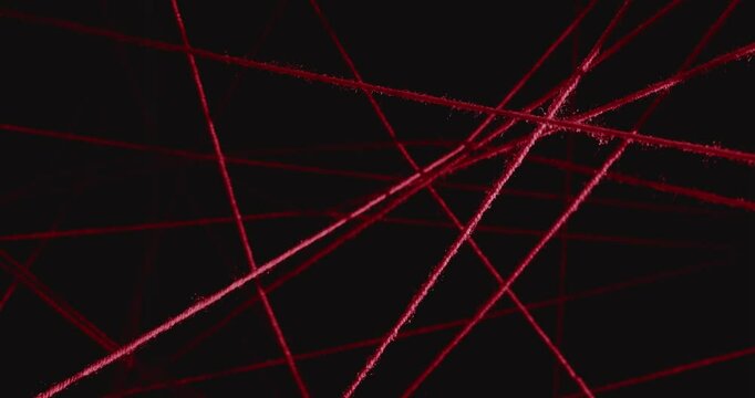 Hand touching a net of stretched red wool threads on a black background. Concept of finding a way out of a difficult situation