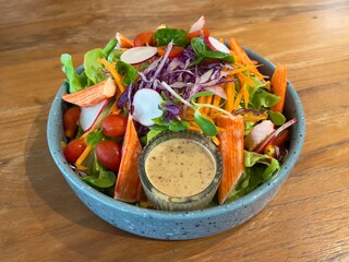 Crab sticks salad served with sesame dressing, selective focus