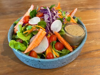 Crab sticks salad served with sesame dressing, selective focus