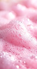 A close-up view of delicate pink foam, glistening and sparkling on the surface, evokes a refreshing and vibrant atmosphere filled with light and energy.