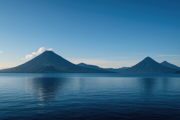 Wide-angle panorama of a freshwater lake surrounded by volcanic peaks in the mountainous region
