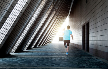Teenage boy running through triangular corridor