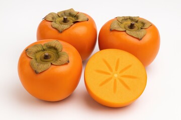 Vivid fresh persimmons displayed against a plain white backdrop