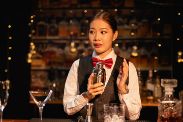  Professional female bartender preparing alcoholic drinks in a bar