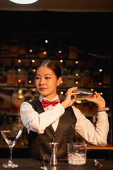  Professional female bartender preparing alcoholic drinks in a bar