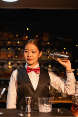  Professional female bartender preparing alcoholic drinks in a bar