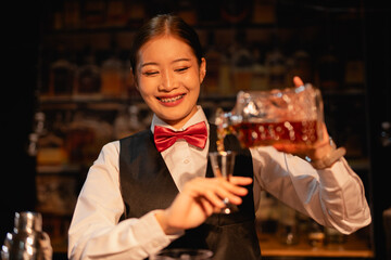 Professional female bartender preparing alcoholic drinks in a bar