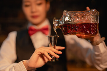  Professional female bartender preparing alcoholic drinks in a bar