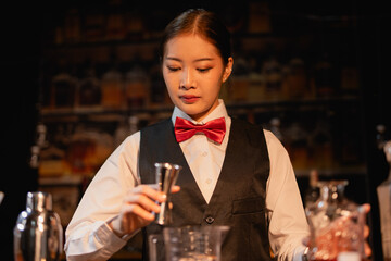  Professional female bartender preparing alcoholic drinks in a bar