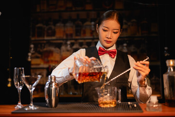  Professional female bartender preparing alcoholic drinks in a bar
