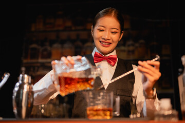  Professional female bartender preparing alcoholic drinks in a bar