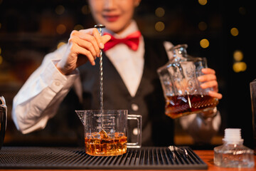  Professional female bartender preparing alcoholic drinks in a bar