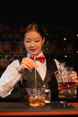  Professional female bartender preparing alcoholic drinks in a bar