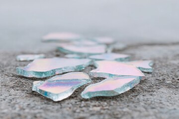 Translucent iridescent shards glisten on cracked asphalt, evoking fractured rainbows in urban fairy tales, celebrating National Poetry Day