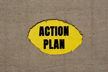 Action plan message written on ripped torn cardboard paper on yellow background. Conceptual action...