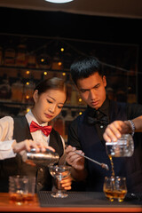  Professional male bartender preparing alcoholic drinks in a bar