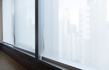 Fototapeta premium Motorized roller blind on big window