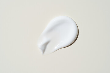 Glossy cream streak on soft beige, highlighting its molten-like shine and velvety richness. A...