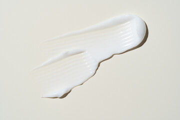 Sleek, reflective cream streak on muted beige, clean and versatile for beauty branding, packaging...