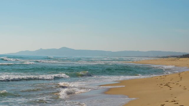 Seascape landscape of the morning beach with turquoise water and light suns at low tide rip current
