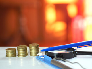 Coins with black magnifying glass. Saving money and financial business concept.Copy space.