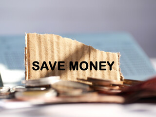 "SAVE MONEY" wording or text on brown paper with coin. Finance and  business concept.