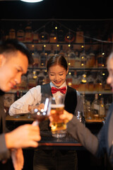 Professional female bartender preparing alcoholic drinks in a bar