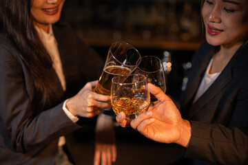 food and drink male friends are happy drinking beer and clinking glasses at a bar or pub.
