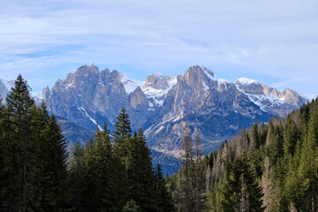 March 2025: winter landscape at Ski Area in Dolomites, Italy - Alpe Lusia. Ski resort in val di Fassa near Moena. Winter Dolomites and blue sky. Aerial view on ski slopes