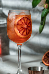 Classic Aperol Spritz cocktail. Aperol, prosecco and soda water served with sliced orange in wine glass close up. Italian summer cocktail