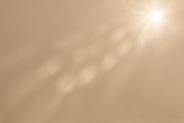 Bright sunlight glare over a beige abstract background with a natural glow effect