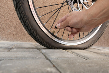 Flat tire on electric bike, pumping air into bike inner tube, bike inspection