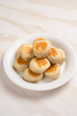 Bakpia is a flat round cookie, made from a mixture of green beans and sugar, then wrapped in flour dough and baked. This cookie is popular as a typical Yogyakarta souvenir.
