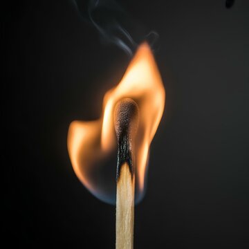 burning match on black background