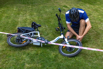 Cyclist with a broken leg and sprained ankle after an electric bike accident, the accident area is...