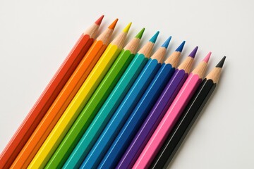 Fototapeta premium Vibrant assortment of colored pencils on a plain white backdrop