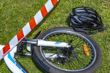 The scene of a bicycle accident surrounded by red and white warning tape, a cyclist's accident,
