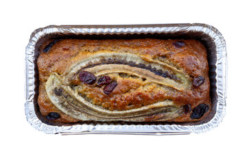 top view, homemade Banana cake topping with banana and cranberry in aluminum foil packaging...