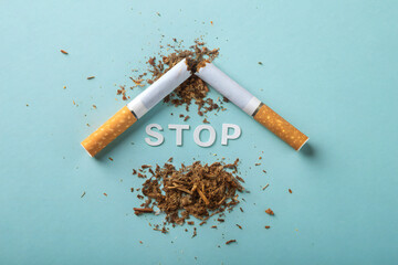 Broken Cigarette on Blue Background with STOP Message – Anti-Smoking Concept for Health Campaigns, Quitting Addiction, No Smoking Awareness