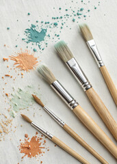 Fototapeta premium Flat Lay of Artist Paintbrushes with Colorful Powder Pigments on Canvas – Creative Art Supplies, Painting Tools for Fine Art and DIY Projects
