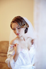 A woman in a white dress is posing for a picture