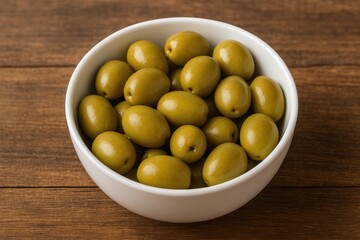 Green pickled olive served in a white bowl on a rustic wooden surface