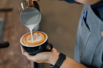 Barista preparing espresso with a modern coffee machine at a stylish café. Close-up of hand using a portafilter in a small business coffee shop. Professional barista equipment in a contemporary SME 