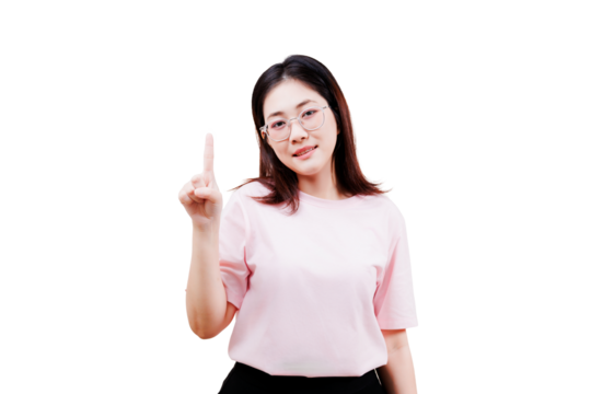 Asian young beautiful woman wearing glasses and a pink shirt is holding up her index finger, smiling confidently at the camera.