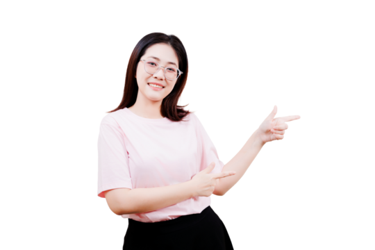 Asian smiling young woman wearing glasses and a light pink shirt point to her right with both hands.