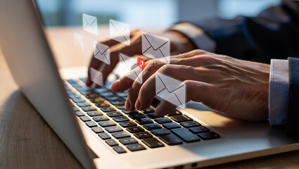 Typing on Laptop with Email Notification Icons Overlaid Business Professionalism