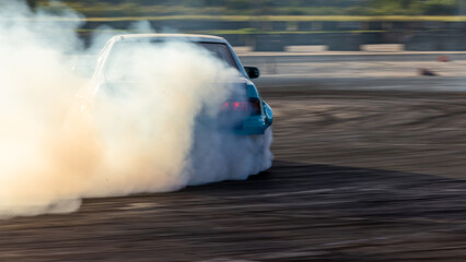 Car drifting, Blurred image diffusion race drift car with lots of smoke from burning tires on speed track, Car drifting on speed track. © Kalyakan