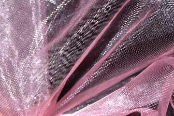 Close up of pink organza silk fabric in delicate waves for background
