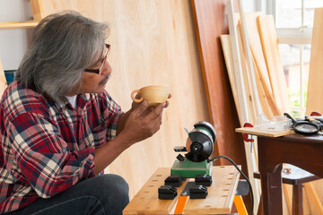Senior people retirement lifestyles concept, Asian senior carpenter working in carpentry studio...