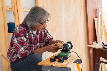 Senior people retirement lifestyles concept, Asian senior carpenter working in carpentry studio...